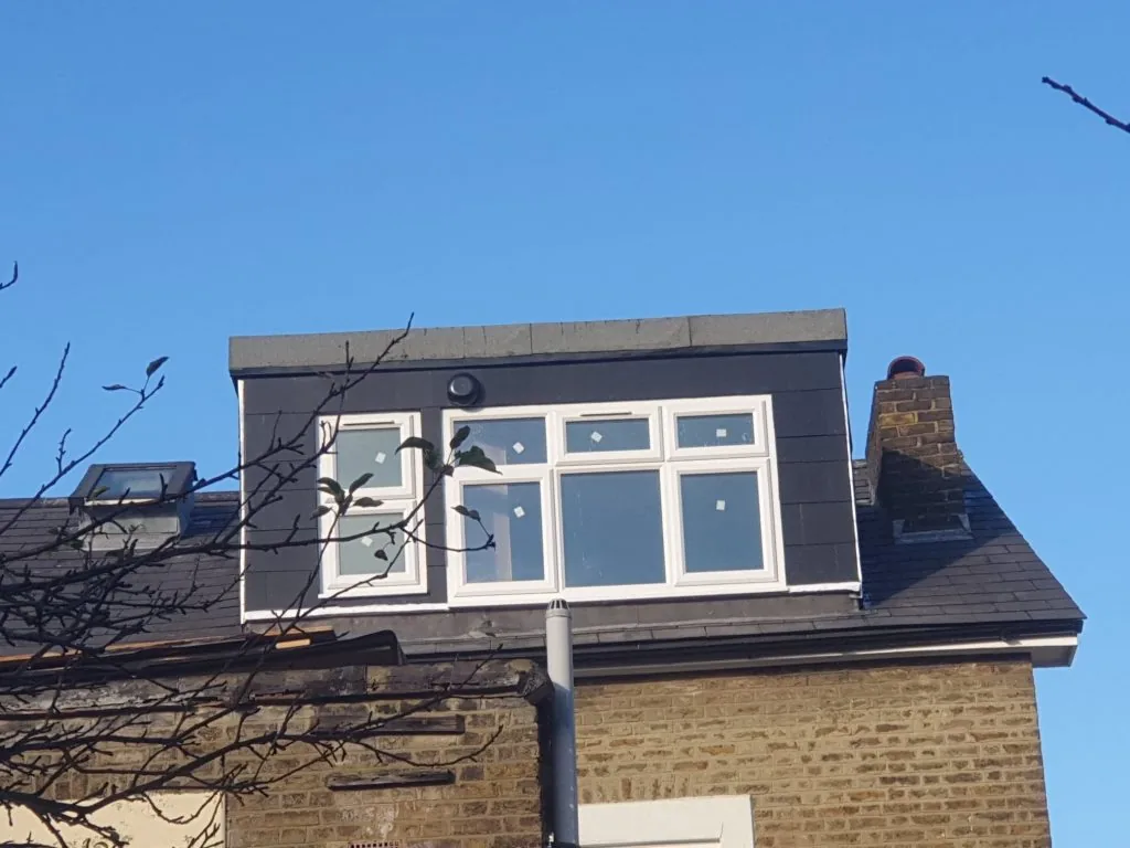 Rear dormer loft conversion with dark cladding and white windows