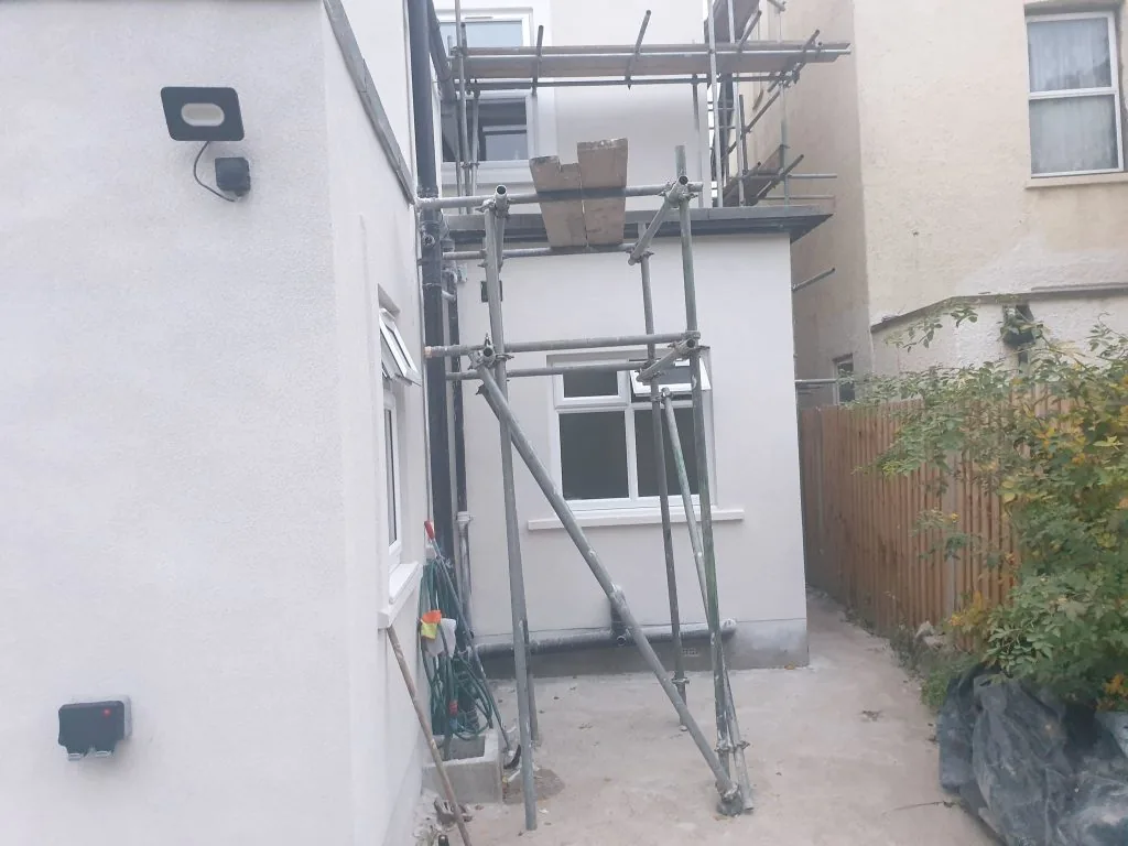 Rear extension with a white render finish, scaffolding still in place