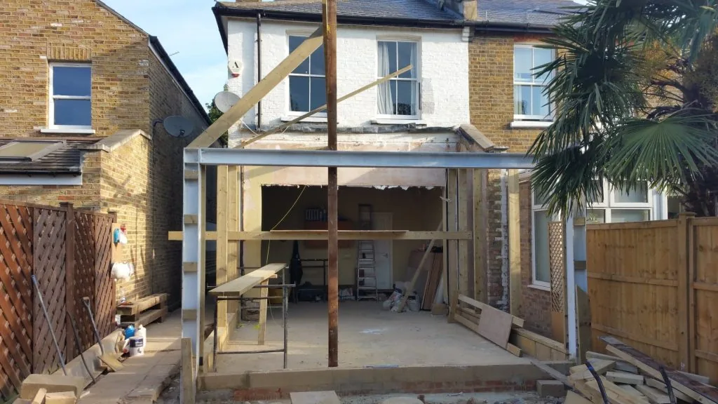 Rear house extension under construction, with a steel beam and timber frame in place